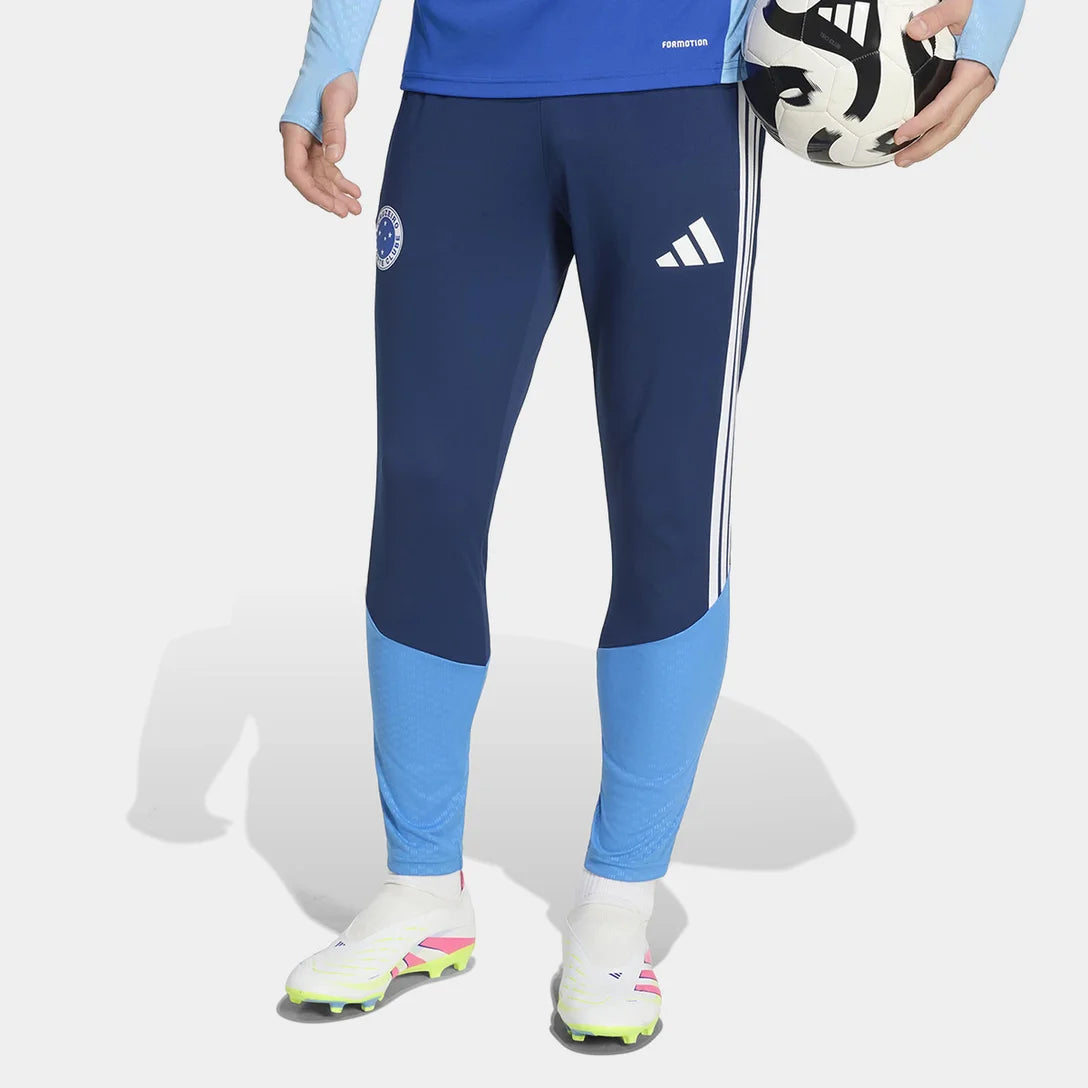 Calça de Treino Adidas Cruzeiro 26/27, Camisa Futebol, Adidas, CALÇA CRUZEIRO 26/27 TREINO Atualize sua coleção celeste com a Calça Cruzeiro 26/27 Treino Adidas Masculina! Desenvolvida para os craques da Raposa que buscam alta performance, esta calça de treino do Cruzeiro é a escolha perfeita para os torcedores. Com um design moderno em dois tons de azul, o artigo conta com as clássicas três listras na lateral e o escudo do Cabuloso em destaque na perna, ideal para exibir sua paixão com estilo e conforto. C