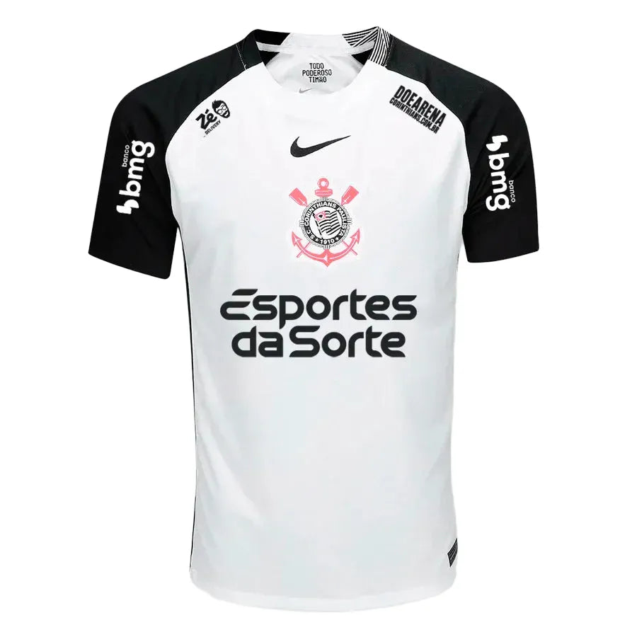 Camisa Nike Corinthians 25/26 Home C/ Patrocínios, Camisa Futebol, Adidas, Ficha do Produto O DIA QUE A LOUCURA VIROU MUNDIAL Inspirada no mundial de 2000, a nova camisa I do Corinthians é inteiramente branca, com as áreas do ombro em preto, e o escudo do Corinthians e o swoosh centralizados no peito, em referência à icônica camisa campeã mundial. Dentro da gola, à altura do pescoço, um emblema com a inscrição "Todo Poderoso Timão" homenageia o grito que ganhou popularidade durante a competição e empurrou o